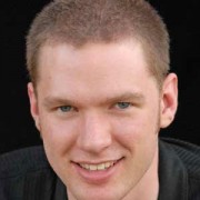 Smiling young man with close-cropped light brown hair